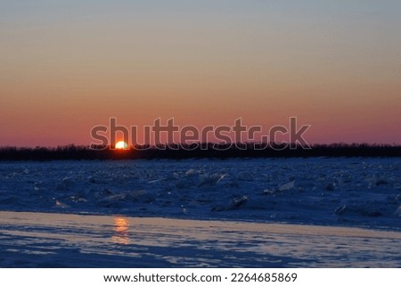 Winter sunset in the city on the Amur