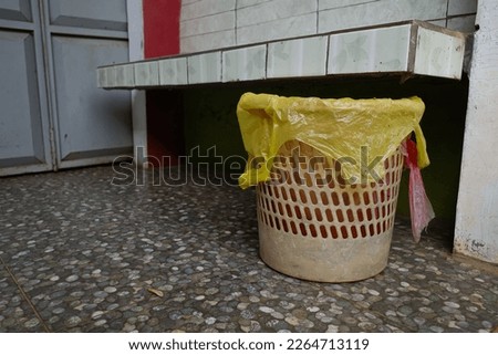 trash can with yellow plastic