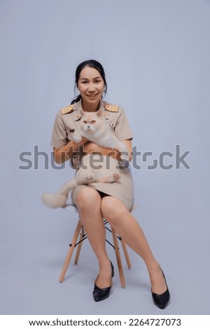 Asian female teacher, Thai teacher in uniform with his lovely cat on a white background