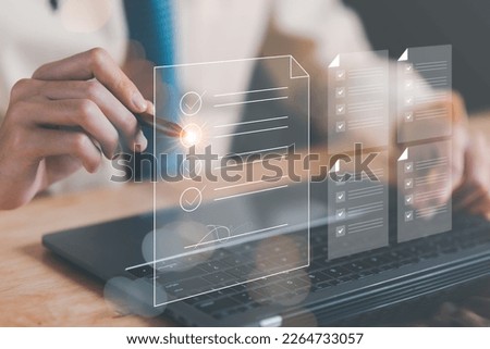Businessman Audit online documents, quality assessment management With a checklist, business document evaluation process, market data report analysis and consulting, plan review process. Royalty-Free Stock Photo #2264733057