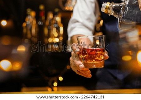 Bartender pouring Whiskey, on  bar, Royalty-Free Stock Photo #2264742131