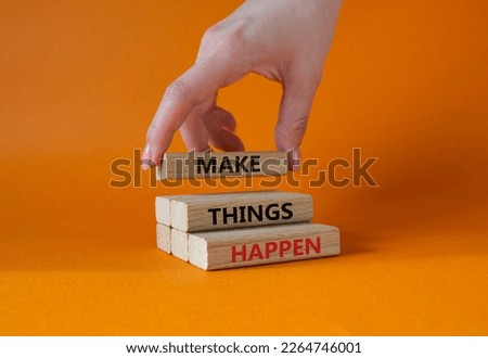 Make things happen symbol. Concept word Make things happen on wooden blocks. Businessman hand. Beautiful orange background. Business and Make things happen concept. Copy space