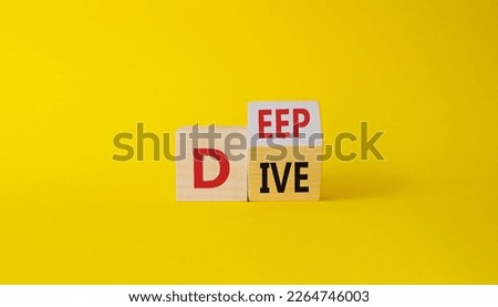 Deep Dive symbol. Concept words deep dive on wooden cubes. Beautiful yellow background. Business and Deep Dive concept. Copy space