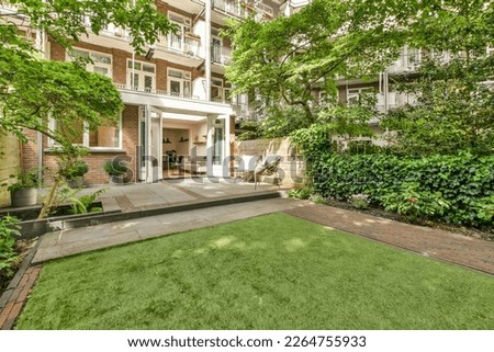 an outdoor area with green grass and trees in the fore - image courtesy by real estate agent, viadeals com