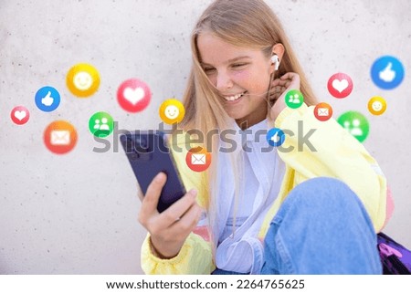 Teenage girl using social media apps on mobile phone Royalty-Free Stock Photo #2264765625