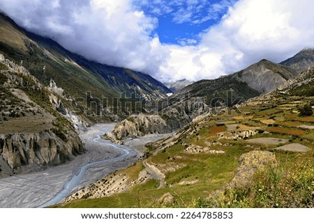 View of the Marshyangdi (Marsyangdi) River valley. Rocky valley of the Marshyangdi river with blue sky in the background. Manang District, Nepal, Asia. Royalty-Free Stock Photo #2264785853