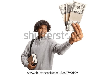 African american male student with a backpack holding books and showing stacks of money isolated on white background