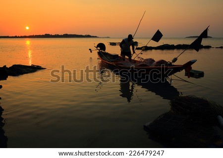 Fisherman working at sunset.