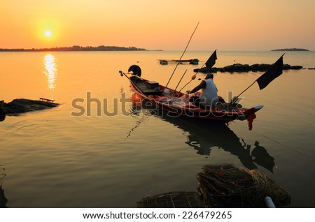Fisherman working at sunset.
