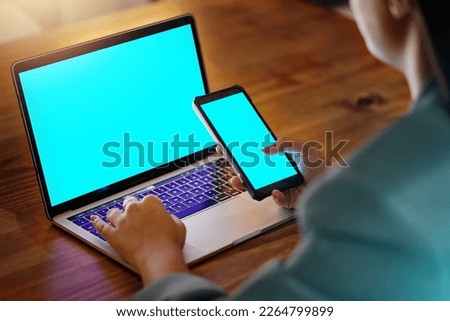 Green screen, mockup and woman with a phone and laptop for marketing, branding and connection. Contact, communication and blank space on a computer and mobile for an employee at advertising business