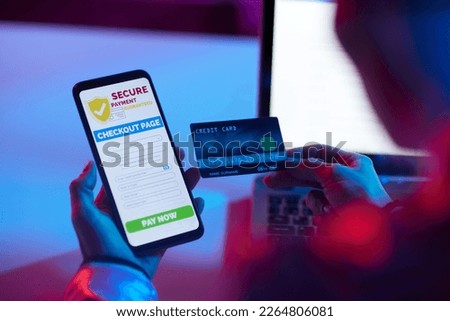 Closeup on modern woman with credit card and smartphone making online purchases on e-commerce website.