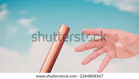 Composition of midsection of caucasian athlete passing orange relay baton. sports and competition concept digitally generated image.