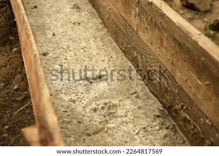 Wooden formwork concrete strip foundation for a veranda in a house. Outdoor construction work.