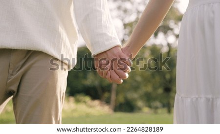 Young adult two fiance asia lover man and woman happy begin couple date life flirt sweet care touch. Asian people bride groom fall in love relax hold hand swear with trust hope on newlywed family day. Royalty-Free Stock Photo #2264828189