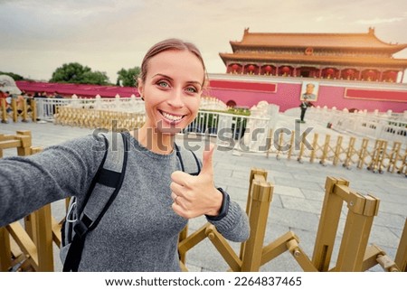 Enjoying vacation in China. Travel and technology. Young woman  taking selfie in Forbidden City, Beijing.