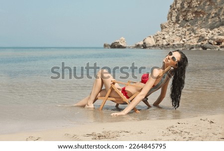 young woman on a deck chair at the beach