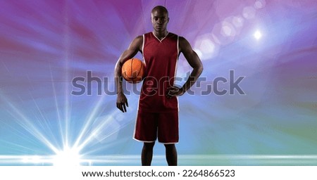 Composition of male basketball player holding basketball with copy space. sport and competition concept digitally generated image.