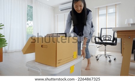 Future of workforce remote work fully permanent. Asia people happy relax move job to new small workspace set up desk picking file folder from box. Keep it chores neat start long term plan career work. Royalty-Free Stock Photo #2264867325