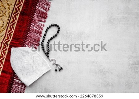 Islamic prayer rug with Muslim rosary with silver crescent moon. Islamic bsckground.