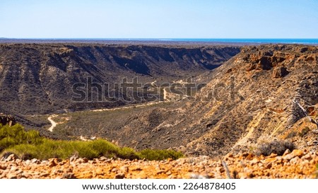 panorama of charles knife canyon in cape range national park in western australia near exmouth; australian outback, red rocks and ocean in the background	