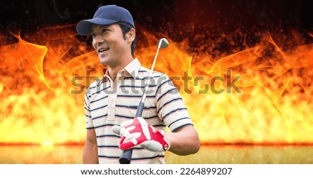Composition of male golf player over flames on black background. sport and competition concept digitally generated image.