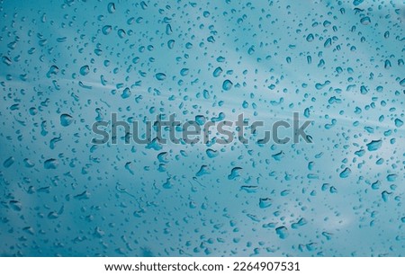 Wet surface. Raindrops on a mirror surface. Dew drops. Condensate. Misted glass.