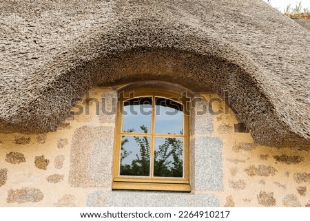 Close-up of cottage with dormer thatched roof Royalty-Free Stock Photo #2264910217