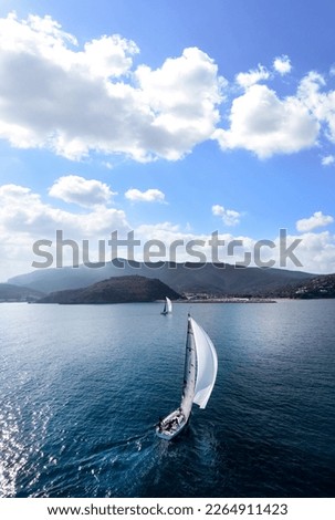 Racing sailboat sailing with white jennaker Royalty-Free Stock Photo #2264911423