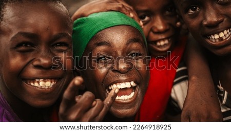 Close Up Of the Faces of a Group of Rural African Young Boys Smiling, Laughing and Posing for Camera. A Group of Expressive Black Male Friends Enjoying Their Childhood and Joking Around Together Royalty-Free Stock Photo #2264918925