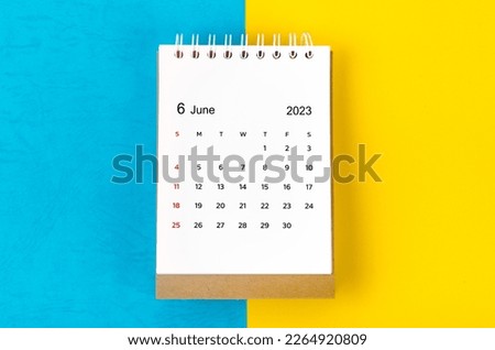 June 2023 Monthly desk calendar for 2023 year on blue and yellow background. Royalty-Free Stock Photo #2264920809