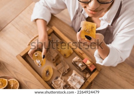 top view of cropped african american woman enjoying flavor of handmade soap in craft workshop Royalty-Free Stock Photo #2264924479