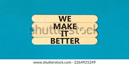 We make it better symbol. Concept words We make it better on wooden stick. Beautiful blue table blue background. Business we make it better concept. Copy space.