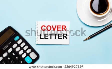 An office desk with a cup of coffee, a calculator, a pen and a blank notebook with the text of the COVER LETTER. Place the workplace and business items flat. View from above.