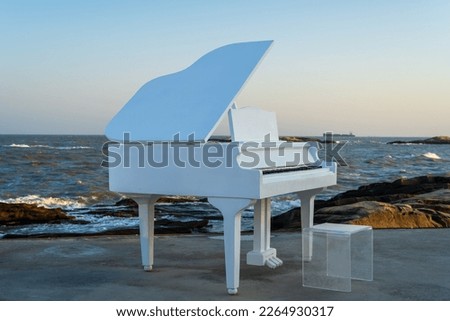 white piano on the beach