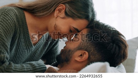 Interracial, couple, love and kiss being happy, bonding and embrace for communication, talking together and at home. Romantic, man and woman with smile, intimate and being loving for romance or hug Royalty-Free Stock Photo #2264932655