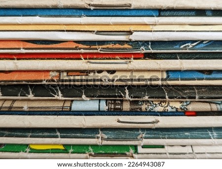 Stack of old vintage comic books creates a colorful background texture with abstract shapes and colors