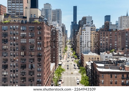 Overhead view First Avenue with traffic drivings through the buildings of Manhattan in New York City, as seen from the Roosevelt Island Tramway Royalty-Free Stock Photo #2264943109