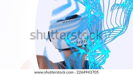 Composition of digital light trails with boy wearing vr headset. global digital interface, technology and networking concept digitally generated image.