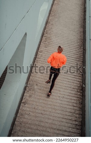 Top view photo of omen in sports clothes running in a modern urban environment. The concept of a sporty and healthy lifestyle