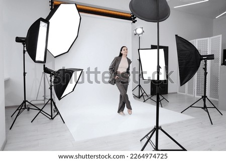 Beautiful young model posing in modern studio. Professional photo session