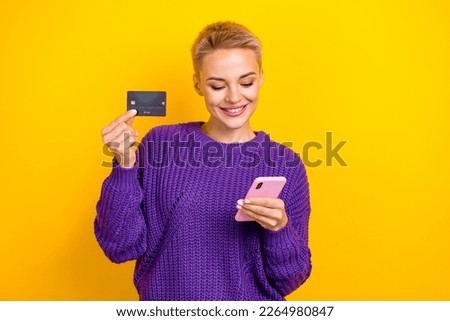 Photo of beautiful pretty blogger young short blonde hairdo hold browse smartphone new shop for ecard bank isolated on yellow color background
