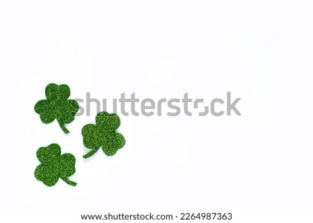 Happy St. Patrick's Day banner.Holiday background.St Patricks Day frame against a white background. Flat lay shamrocks.Copy space.Patrik's day banner Royalty-Free Stock Photo #2264987363