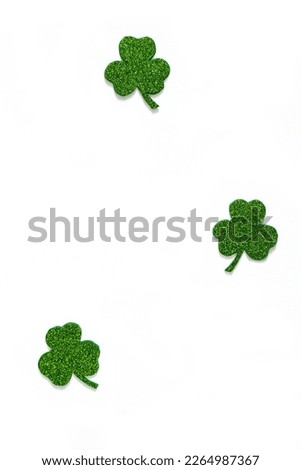 Happy St. Patrick's Day banner.Holiday background.St Patricks Day frame against a white background. Flat lay shamrocks.Copy space.Patrik's day banner Royalty-Free Stock Photo #2264987367