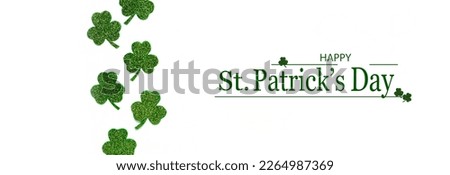 Happy St. Patrick's Day banner.Holiday background.St Patricks Day frame against a white background. Flat lay shamrocks.Copy space.Patrik's day banner Royalty-Free Stock Photo #2264987369