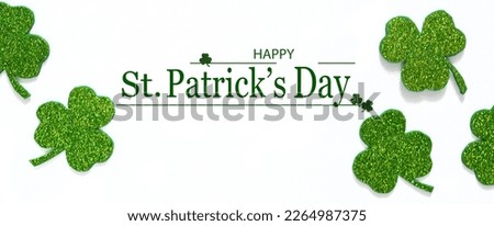 Happy St. Patrick's Day banner.Holiday background.St Patricks Day frame against a white background. Flat lay shamrocks.Copy space.Patrik's day banner Royalty-Free Stock Photo #2264987375