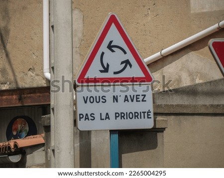 Regulatory signs, give way or yield traffic sign written in French: Vous n'avez pas la priorite translated You do not have any priority rights