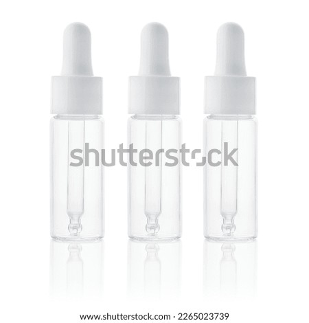 Glass bottle with pipette. Empty glass bottle with dropper, liquid essential and collagen serum isolated on white background. Cosmetic bottle of moisturizing face serum with pipette.  Royalty-Free Stock Photo #2265023739