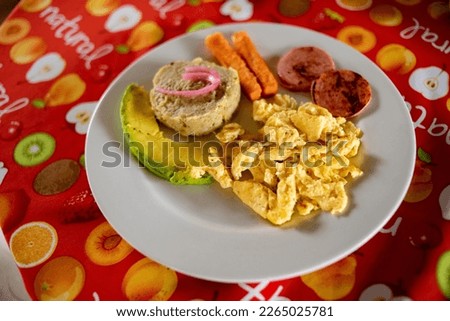 
Dominican breakfast with salami cheese avocado and scrambled eggs and mangu of bananas and onion. Breakfast with the three strokes Royalty-Free Stock Photo #2265025781