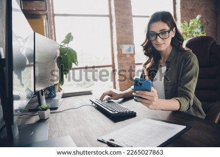 Profile photo of smart agent girl sitting chair keyboard typing use telephone open space indoors