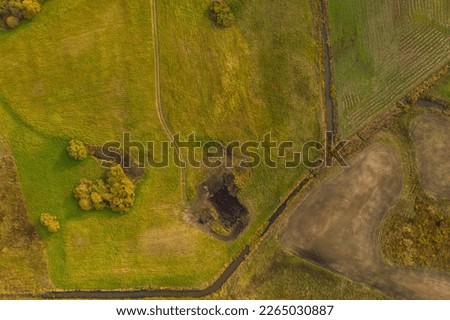 Drone photography of rural road going through farmlands during summer evening